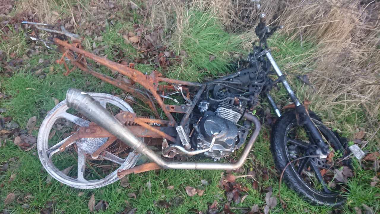 An abandoned and burned Kymco - the fuel tank is out of shot